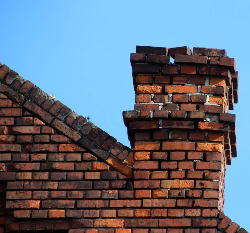 Signs Your Burr Ridge Home Needs a Chimney Inspection Damaged chimney on an Burr Ridge home showing cracks and missing mortar